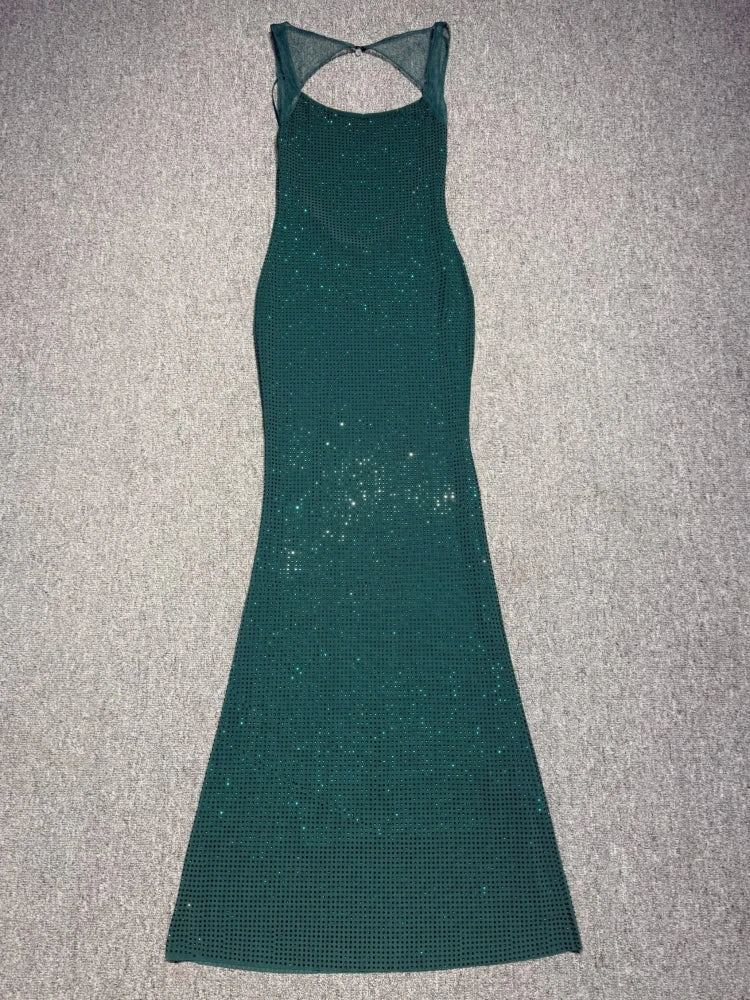 Green dress with cut-out back on a gray surface