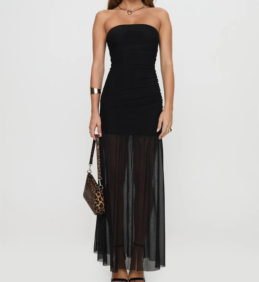 Black strapless dress with sheer overlay worn by a model on a white background