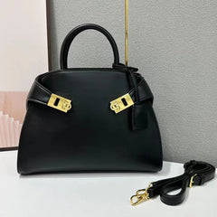 Black leather satchel bag with gold hardware