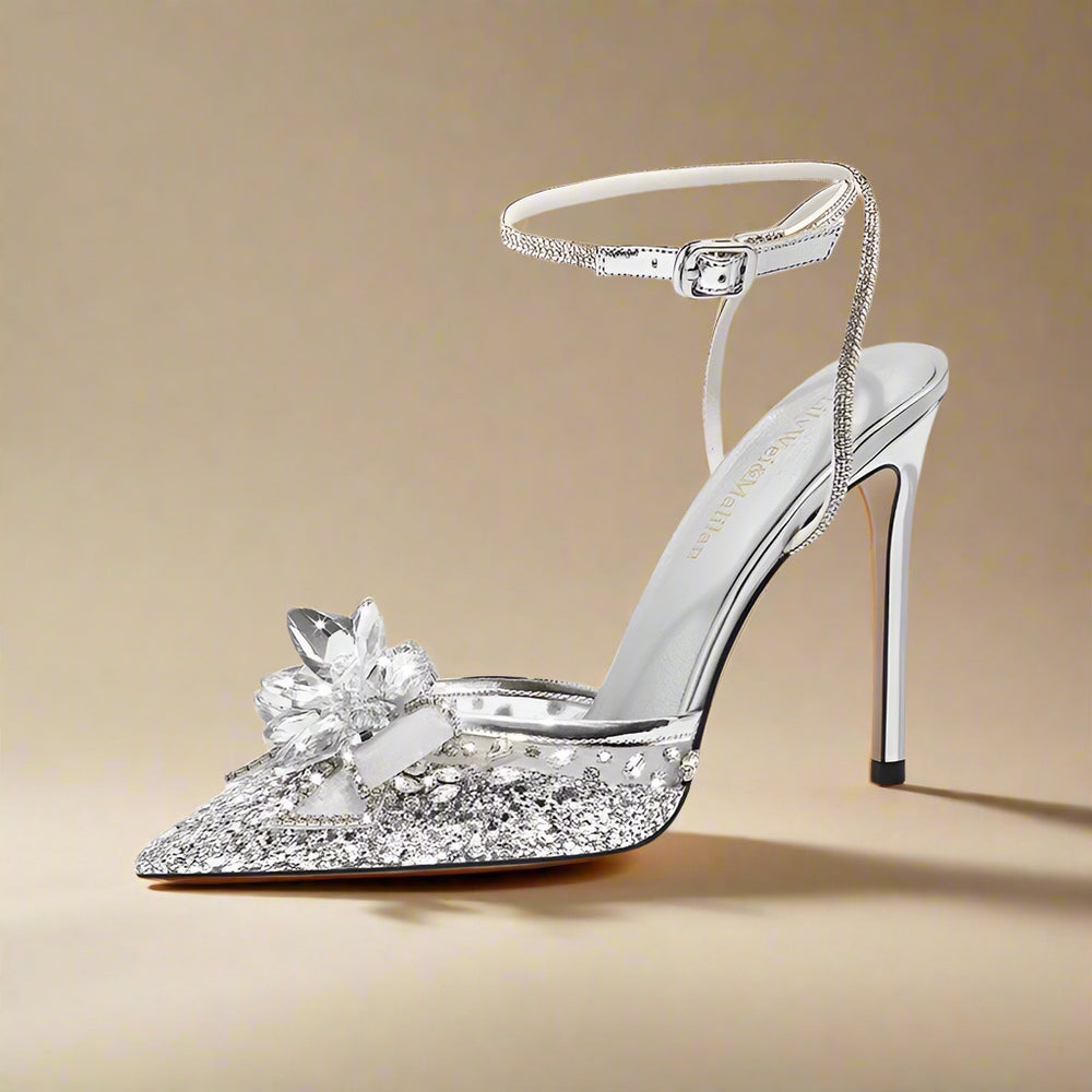 Silver high-heeled shoe with floral design on a white background