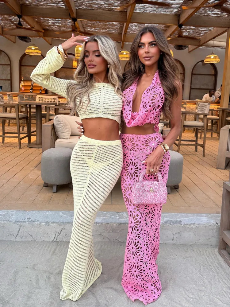 Two women posing in stylish outfits in an outdoor setting.