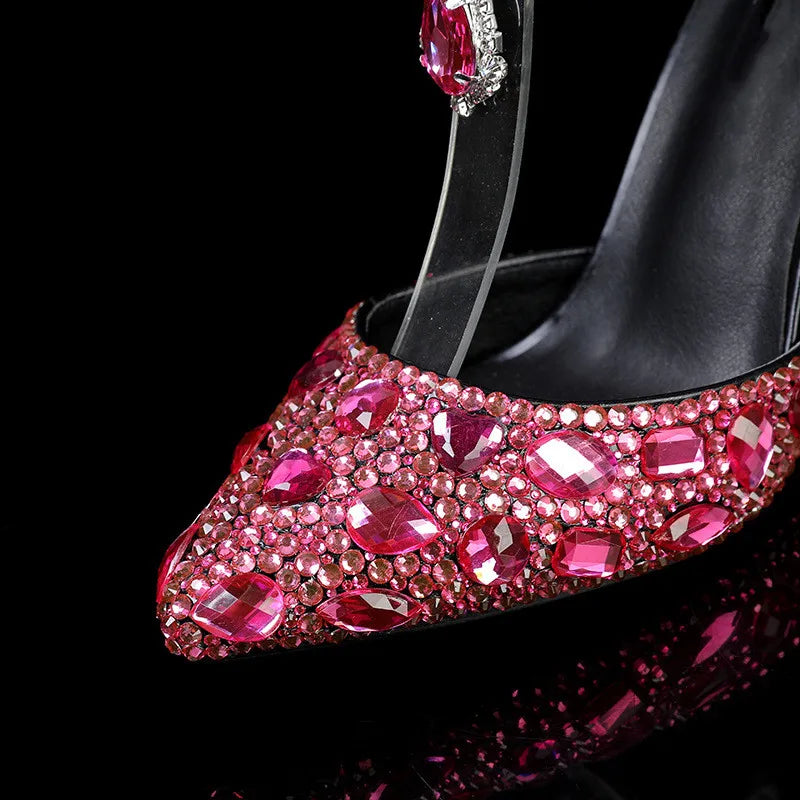 Black high-heeled shoe with pink gemstones on a black background