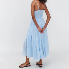 Woman wearing a light blue dress on a white background