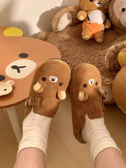 Brown cartoon bear flannel slip-on slippers on feet