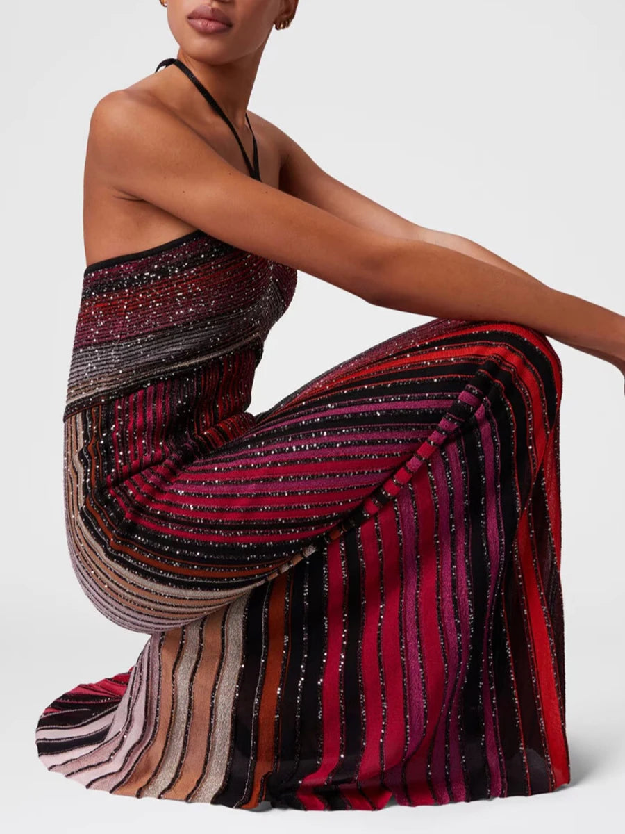 Woman wearing a colorful striped dress on a white background