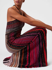 Woman wearing a colorful striped dress on a white background