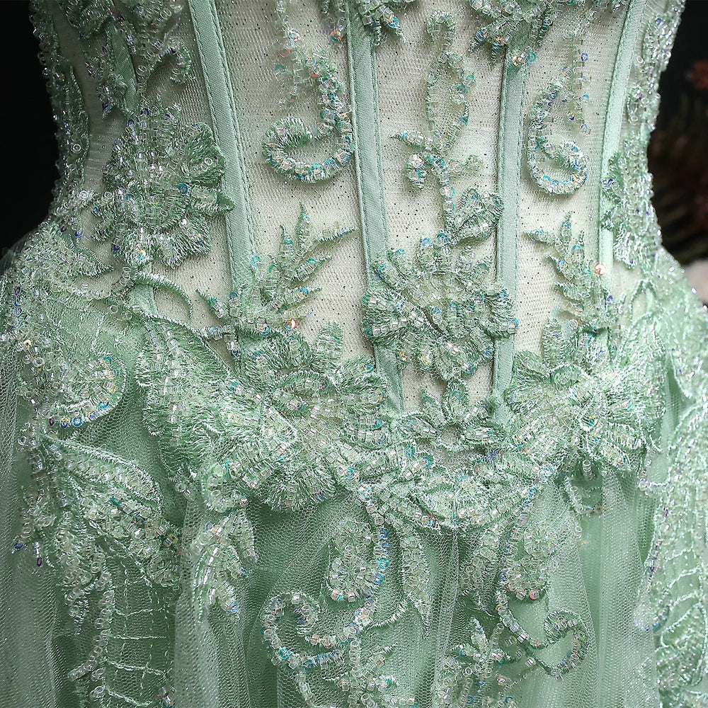 Close-up of a green embroidered fabric with intricate patterns
