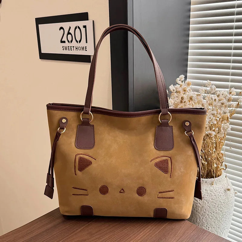 Brown suede-like tote bag with a cat face design