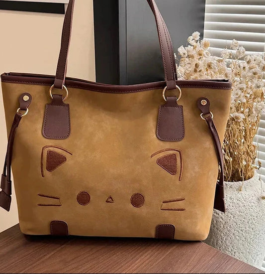 Brown suede-like tote bag with a cat face design