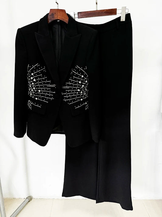 Black beaded blazer and straight leg pants hanging on a rack