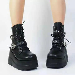 Black platform boots with buckles on a white background
