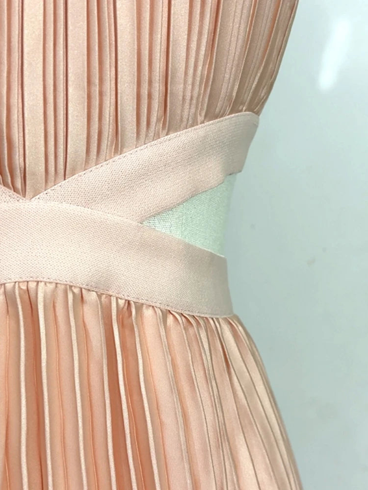 Close-up of a pleated dress with a light blue background