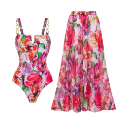 Floral print one-piece swimsuit and maxi skirt beachwear set laid out