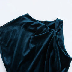 Women's velvet dress with an asymmetric neckline and sleeveless design.