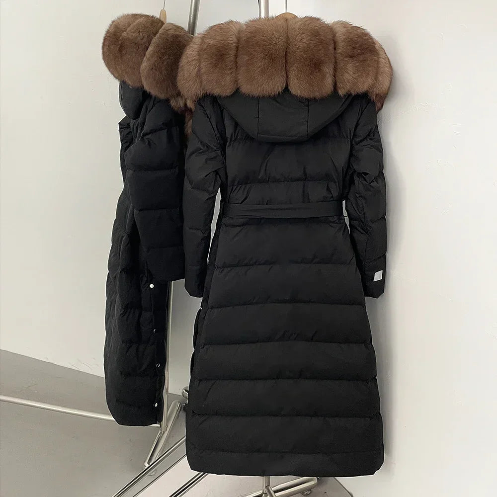 Black puffer coat with brown fur hood on a white background