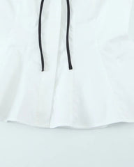White hoodie with black drawstrings on a light gray background