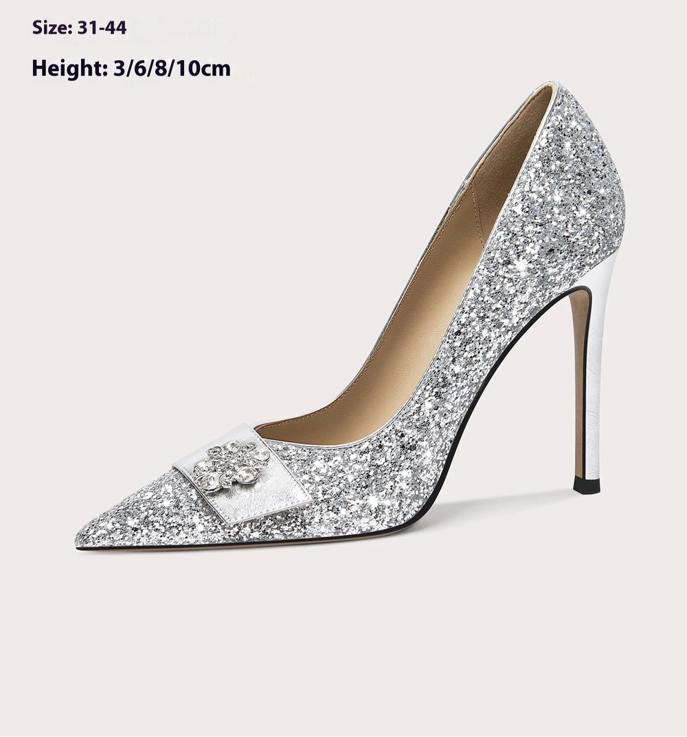 Silver glitter high-heeled shoe with bow detail on a light grey background, 