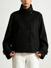 Front view of a black solid cropped jacket with a high stand collar.
