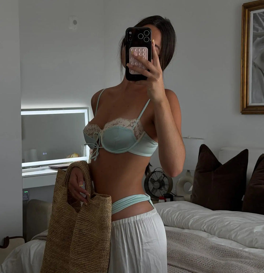 Long light blue satin skirt with lace trim at the hem