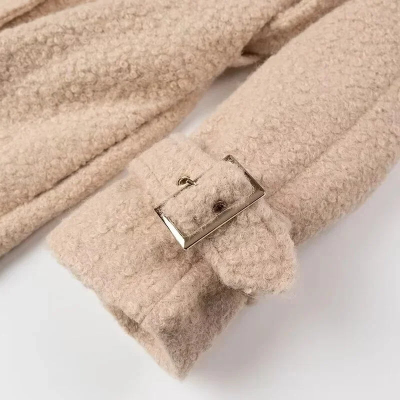 Beige fleece blanket with a buckle on a white background
