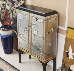 Decorative cabinet with floral and bird design in a room setting.