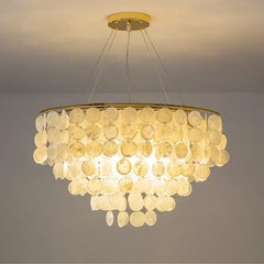 Chandelier with circular design and beige disc-like elements on a plain background