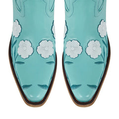 Turquoise cowboy boots with white floral patterns on a white background