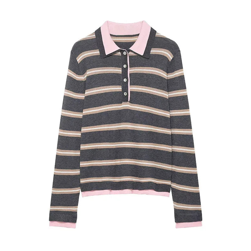 Striped sweater with pink collar and cuffs on a white background
