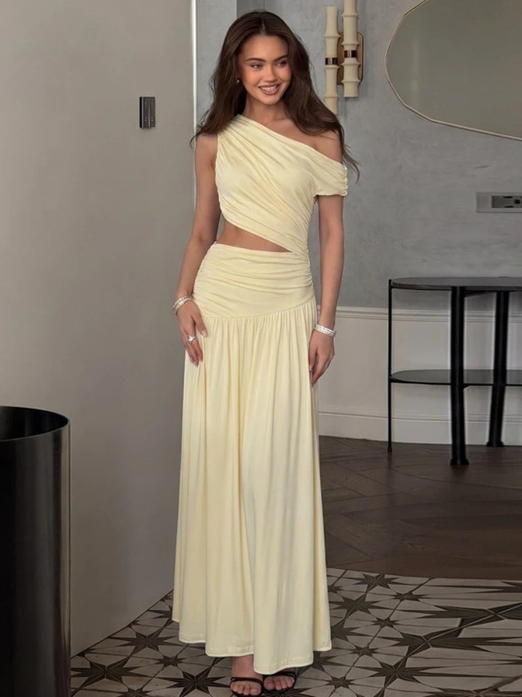 One-shoulder cutout ruched maxi dress on a woman indoors.