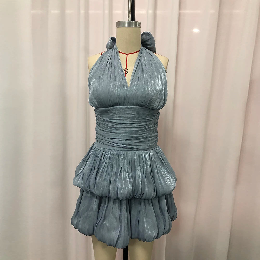 Blue metallic dress on a mannequin against a plain background