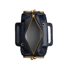 Black leather bag with gold accents on a white background