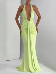 Lime green evening gown with a plunging neckline on a neutral background