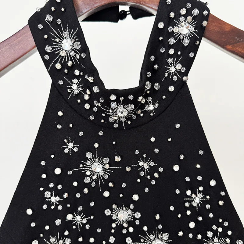 Black dress with silver embellishments on a white background