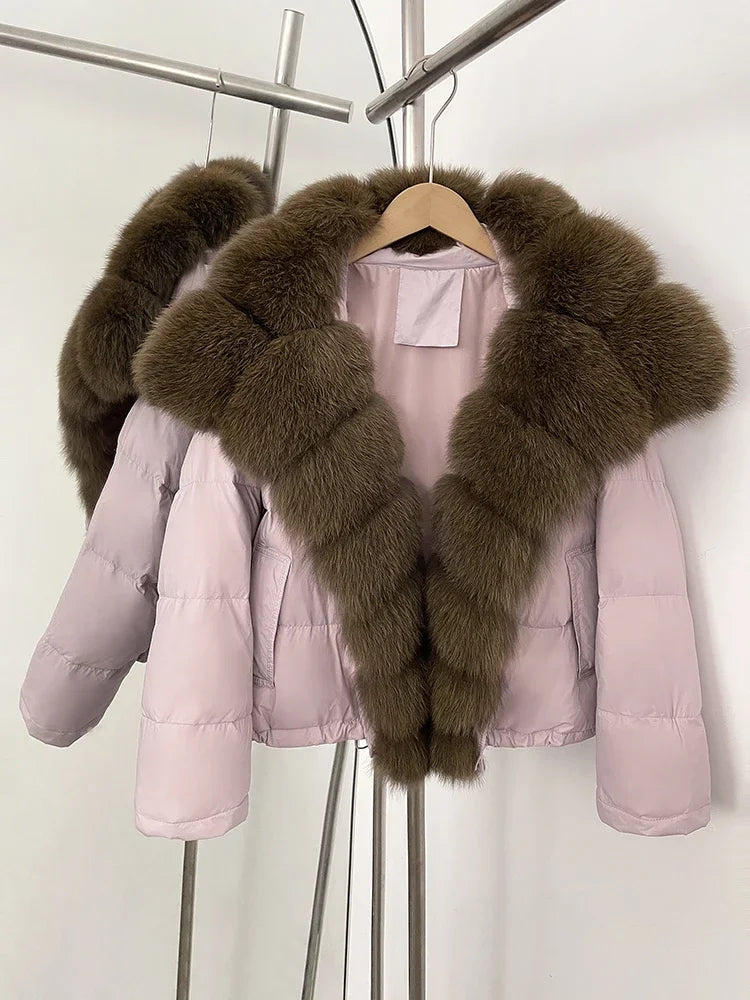 Pink puffer jacket with brown fur trim on a hanger against a white background