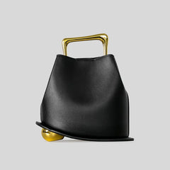 Black handbag with gold accents on a light gray background