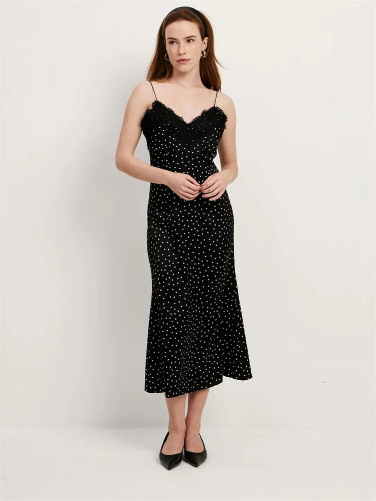 Woman wearing a black polka dot dress on a white background