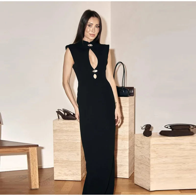 Woman in a black dress standing next to wooden boxes with shoes