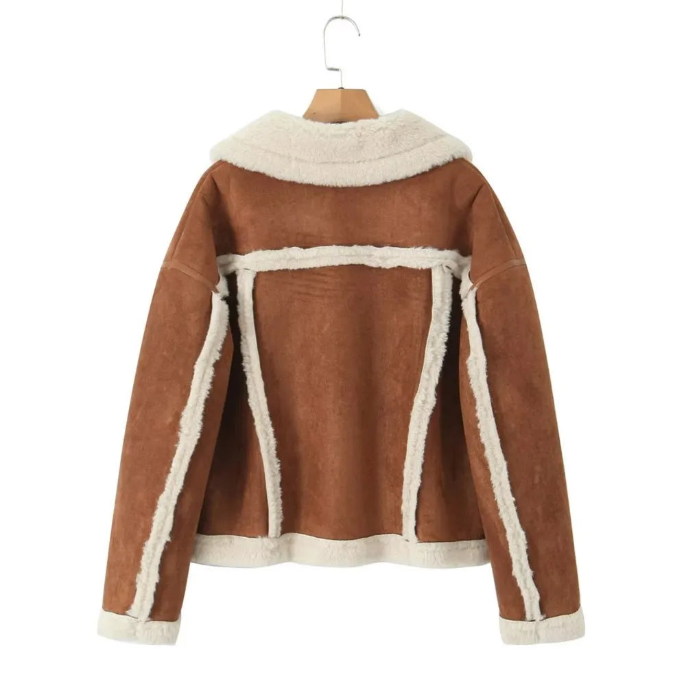 Brown jacket with white trim on a hanger against a white background
