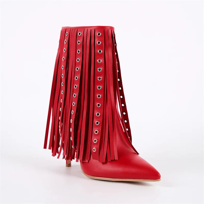 Three-quarter view of red pointed toe ankle boots with fringe detail