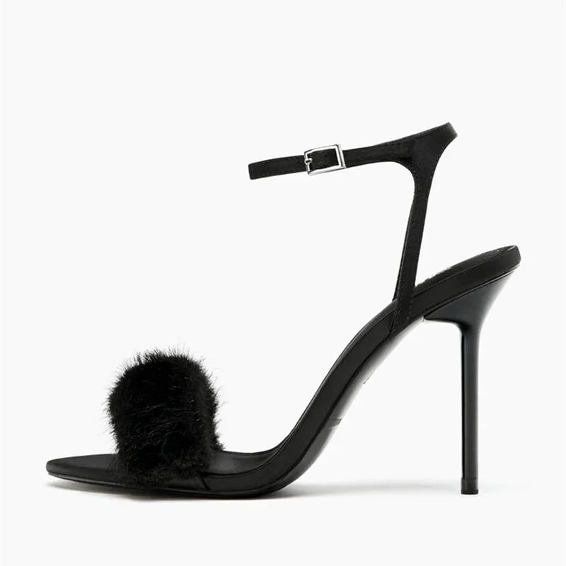 Side view of black faux fur strap stiletto heel sandal