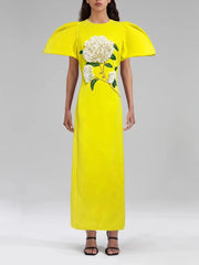 Yellow dress with floral design on a plain background