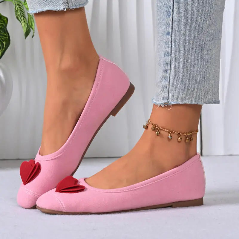 Close-up of pink ballet flats on a model's foot