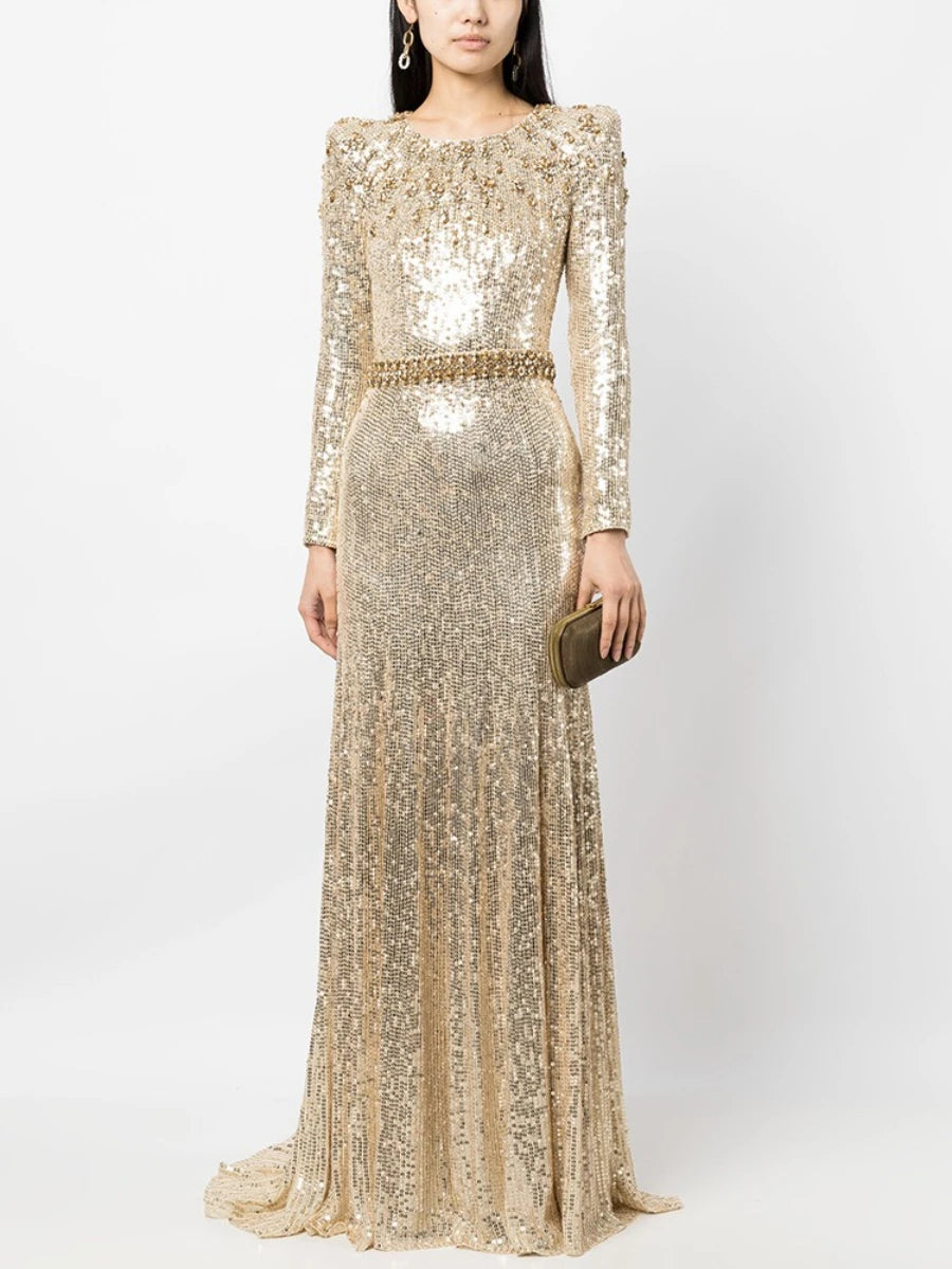 Woman wearing a gold sequin gown on a white background