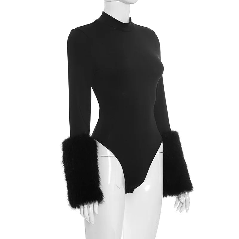 Black bodysuit with fur cuffs on a mannequin against a white background