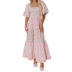 Woman wearing a pink floral dress on a white background
