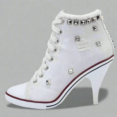 White canvas boots with thin heels and cross straps, showcasing a stylish and modern design. 2