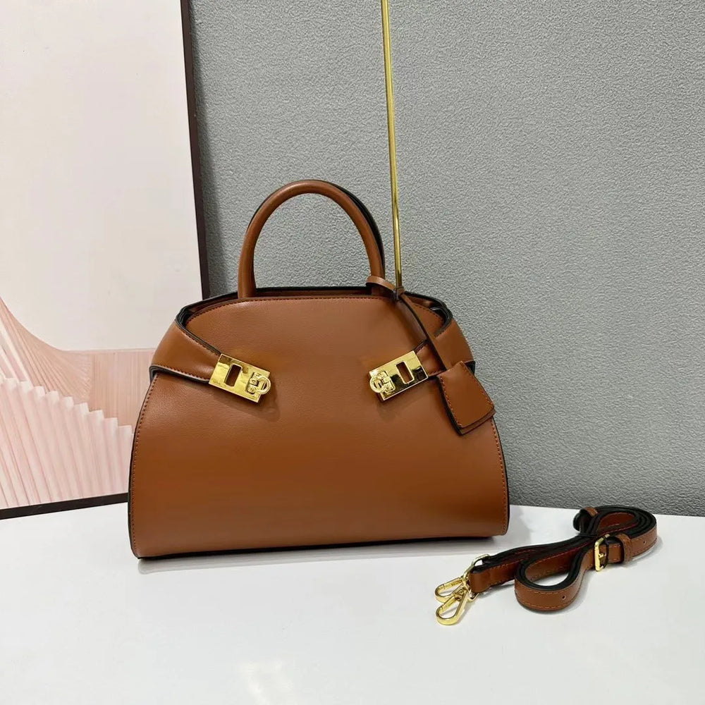 Brown leather satchel bag with gold hardware