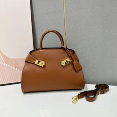 Brown leather satchel bag with gold hardware