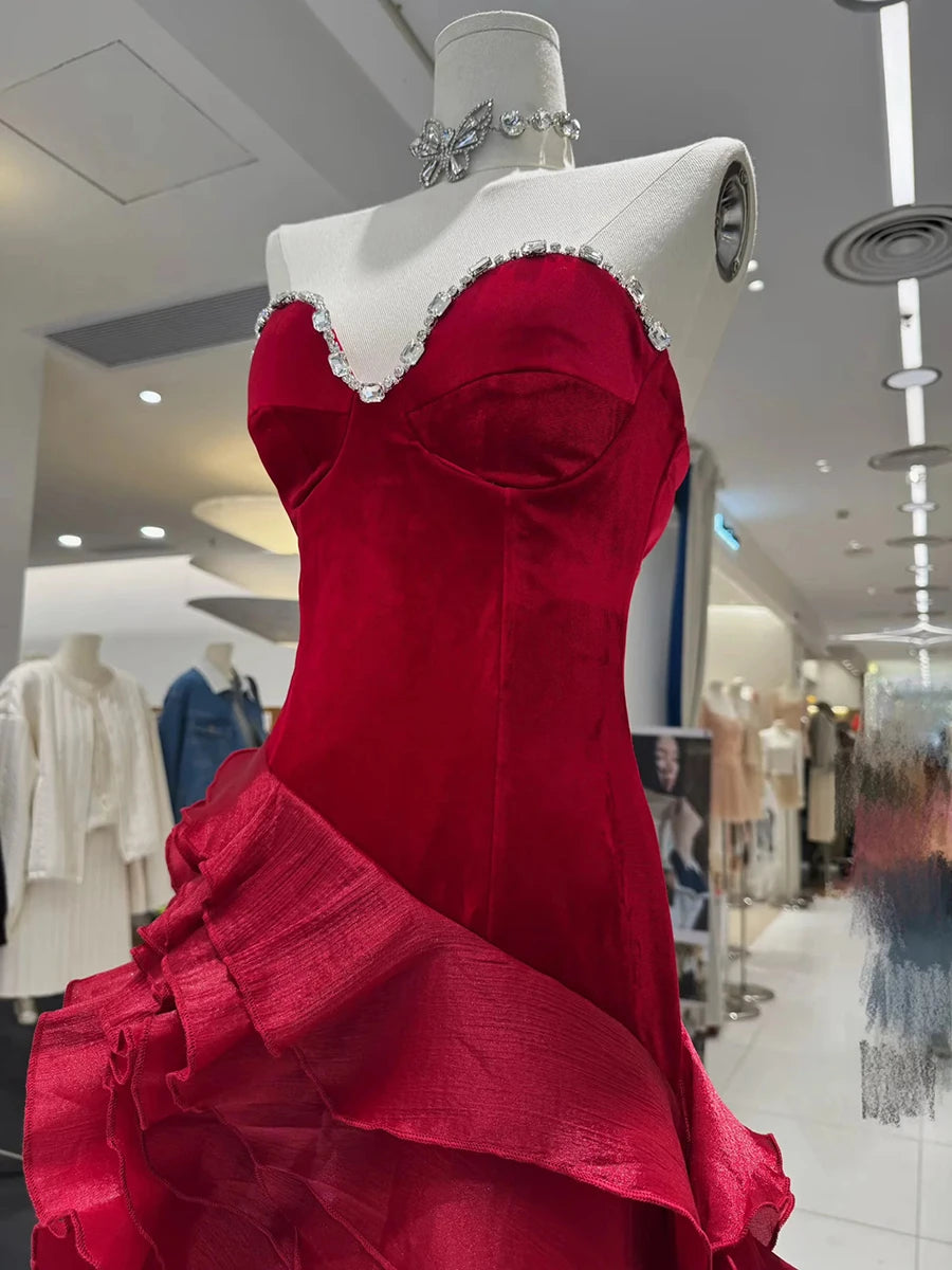Red evening gown on a mannequin in a store setting
