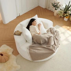 “Side view of round chaise lounge chair with deep seating in living room”


